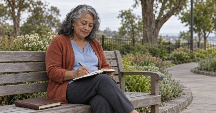 Afterlife Contact and Grief Mature woman writing memories on a bench in a public garden