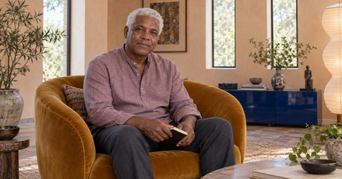 Chakra balancing and informed choices Mature man considering a notebook in a bright sitting room