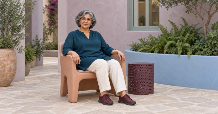 Comfortable grounding in everyday surroundings Mature woman seated with shoes on beside plants in an accessible courtyard.