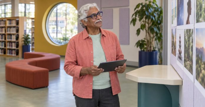 Comparing Immediate Psychic Reading Options A man comparing online reading options on a tablet in a library
