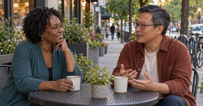 Two adults having a relaxed conversation at an outdoor cafe