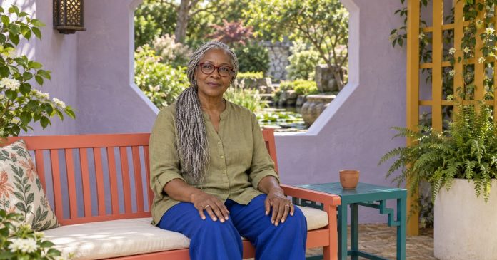 Mature woman taking an attentive pause in a bright garden pavilion.