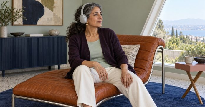 Personal interests and self-respect A mature woman wearing headphones while seated on an orange chaise.